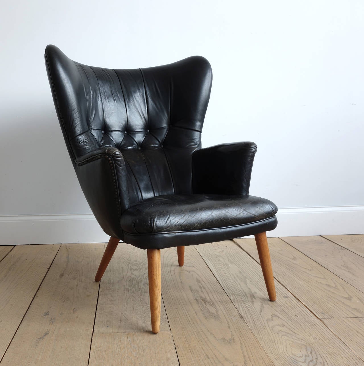 The proportions of this chair are intuitively inviting. The original leather is soft and supple. The design embraces without being close, and it is as comfortable to sit in as it is pleasing to behold. It seems the superior precursor to the papa