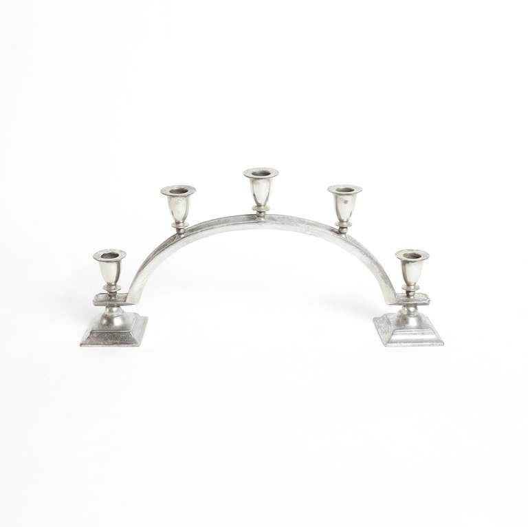 An arch-form candelabra with five candle holders. Marked with Just Andersen's triangle stamp.