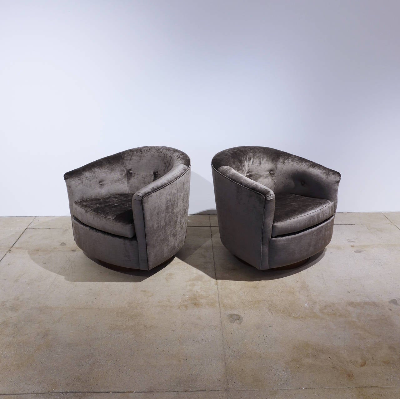 A glamorous pair of swivel rockers by Milo Baughman, reupholstered in a mushroom gray velvet. Price is for the pair.
