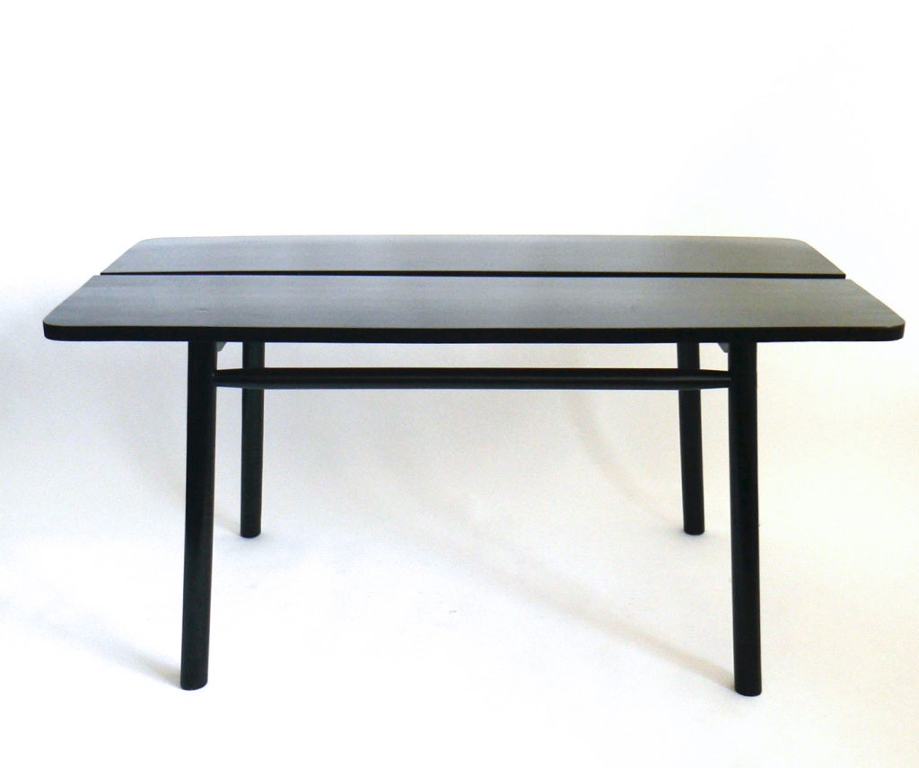 Pierre Gautier-Delaye was one of the great French modernist designers. Like Pierre Chapo and Le Corbusier, he worked with Charlotte Perriand. This table reflects a definite Japanese influence. The legs flare almost imperceptibly and while the
