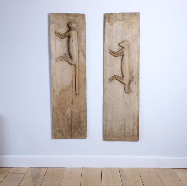From the collection of the avante garde theater director Robert Wilson, a stunning pair of sculpted panels in soft wood with silhouettes of monkeys.