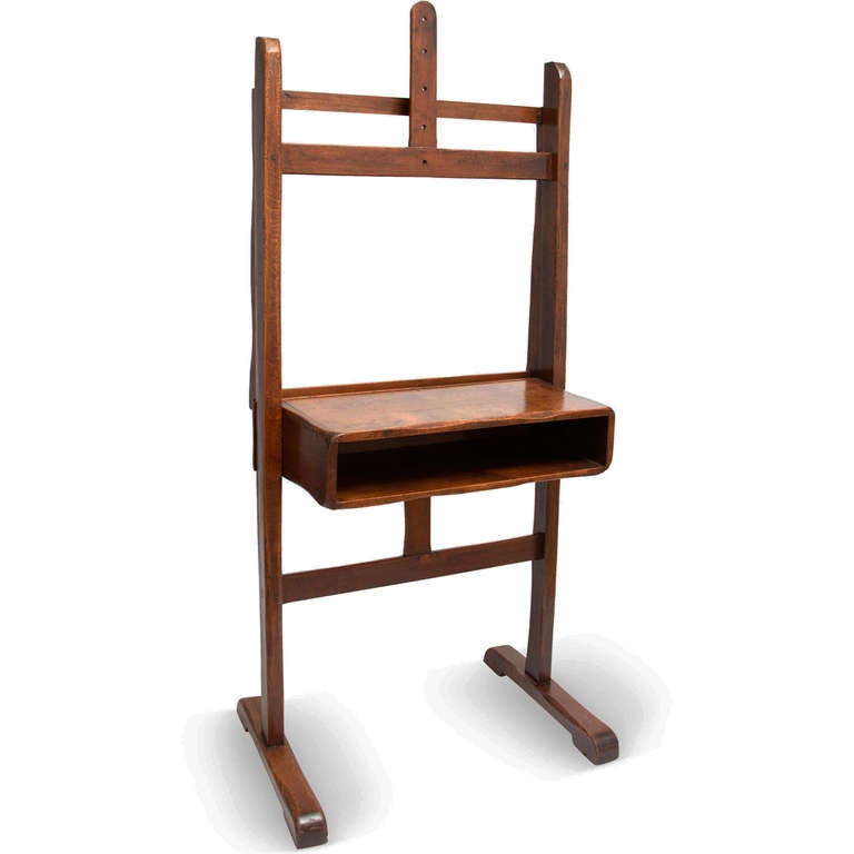 This is a rustic, handmade artist's easel of smooth, beautifully patinated walnut with a deep compartment for art supplies.