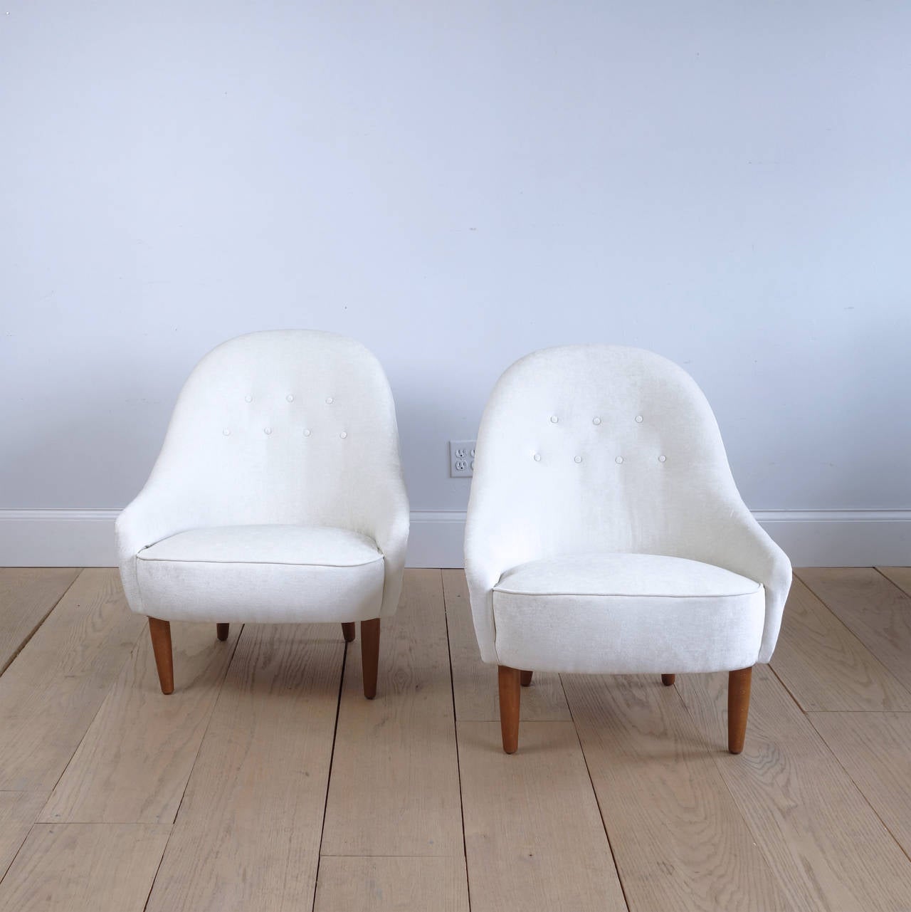 A graceful and exceedingly comfortable pair of lounge chairs probably designed by the unassuming Carl Malmsten, who said 