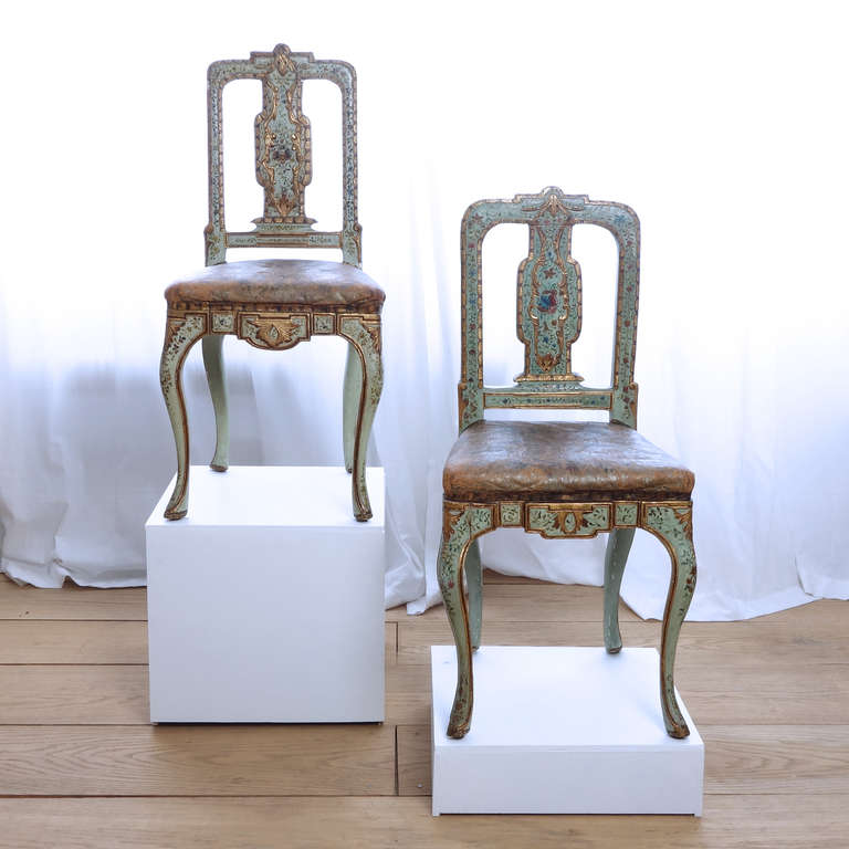 A pair of Italian Rococo green-painted and parcel-gilt carved wooden side chairs, circa 1750.

In Mobili e Mobilieri nella Sicilia del Settecento the creation of these chairs is attributed to "Maestranze trapanesi," or artisans of Trapani,