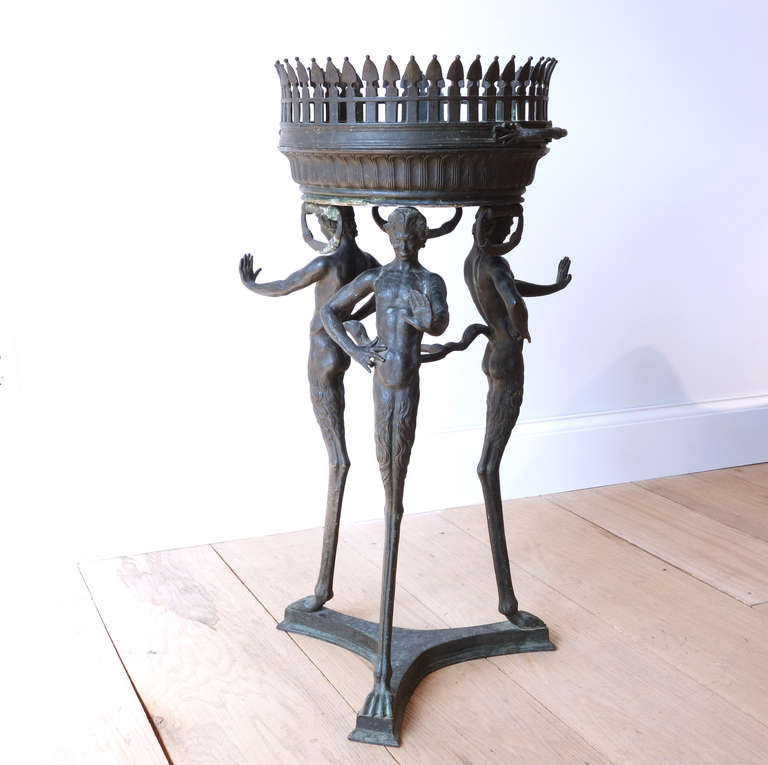 A beautifully patinated bronze tripod jardiniere, its base formed of three handsome satyrs with tails intertwined, from the foundry of Giorgio Sommer. Signed 