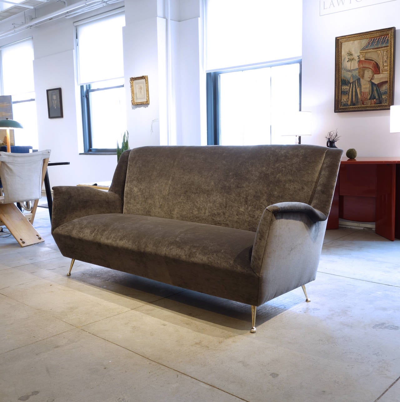 This generously proportioned sofa has been completely restored and covered in a handsome gray velvet. It is of a set with a pair of armchairs, also pictured. They can be purchased together or separately.