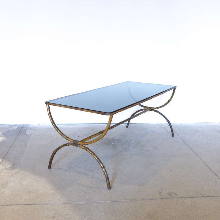 We like the contrast of the gray glass rectangular top with the curvy gilt metal of this table. Simple yet refined.