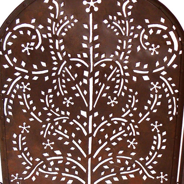 There is a Shaker quality to its simple yet expansive design. We can imagine how the tree of life motif will send dappled firelight onto a wide plank floor. The patina has the burnt earth hue of Cor-ten steel.

Center panel is 24