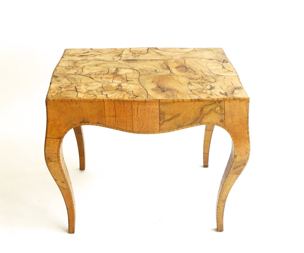 An Italian Neoclassical olive wood table with an expressive burled wood surface.