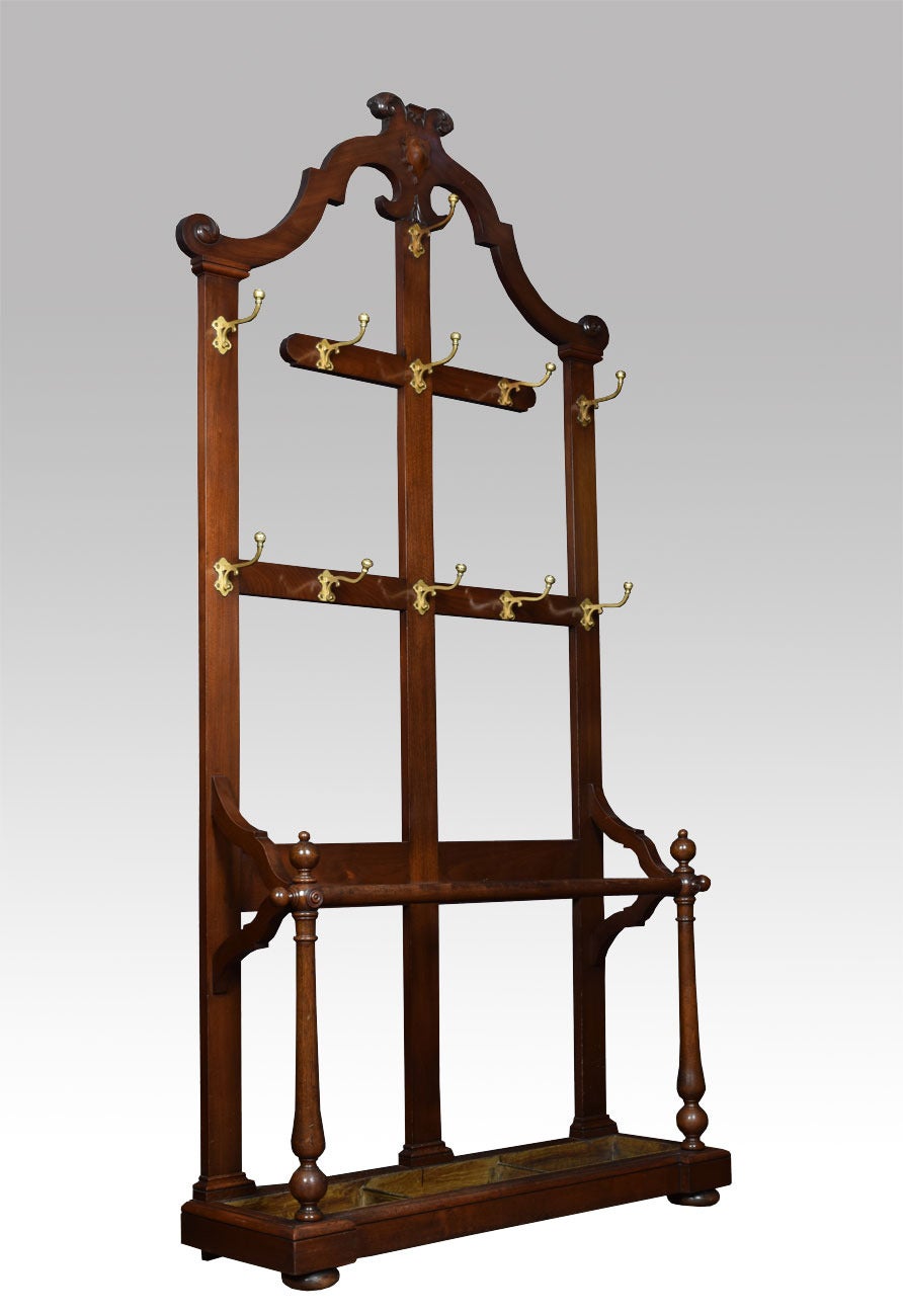 Victorian walnut hall stand the arched top above carved motif to the arrangement of coat hooks the base section fitted with stick/umbrella stand with original drip tray raised up on bun feet

Dimensions

Height 91 Inches

Width 46