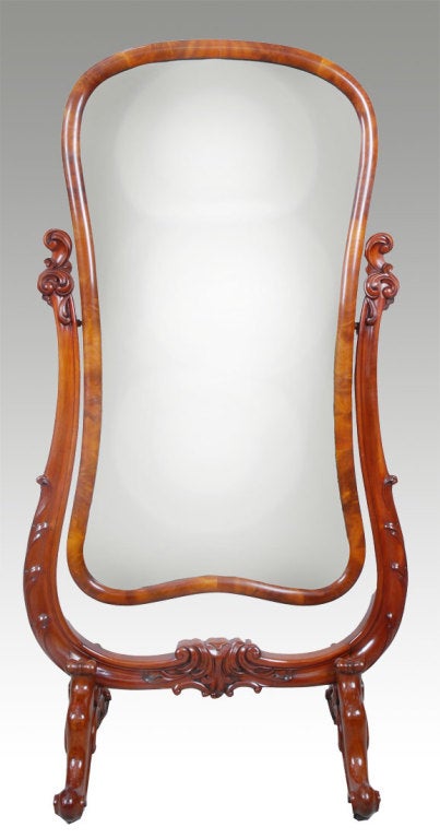 Early Victorian mahogany cheval mirror,  the cartouche-shaped plate mirror  with a moulded frame, supported by a moulded frame having scrolled tendrils raised up on scrolled legs and brass cators.