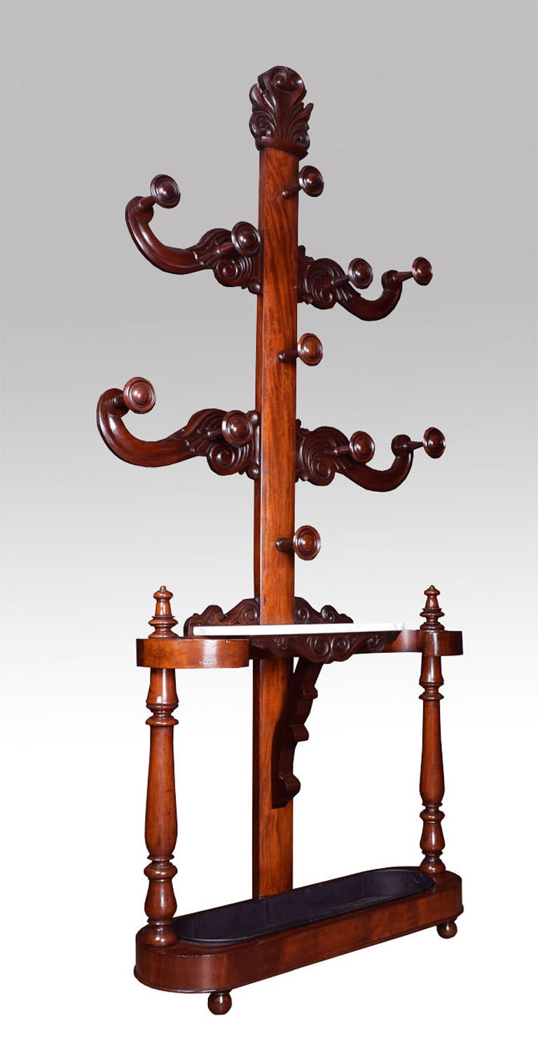 Victorian mahogany "Tree of Life" hall stand, the moulded upright with two turned coat hooks headed by a scrolling carved plume, flanked by four conforming C-scroll arms with eight further hooks, the lower section with a white vined marble