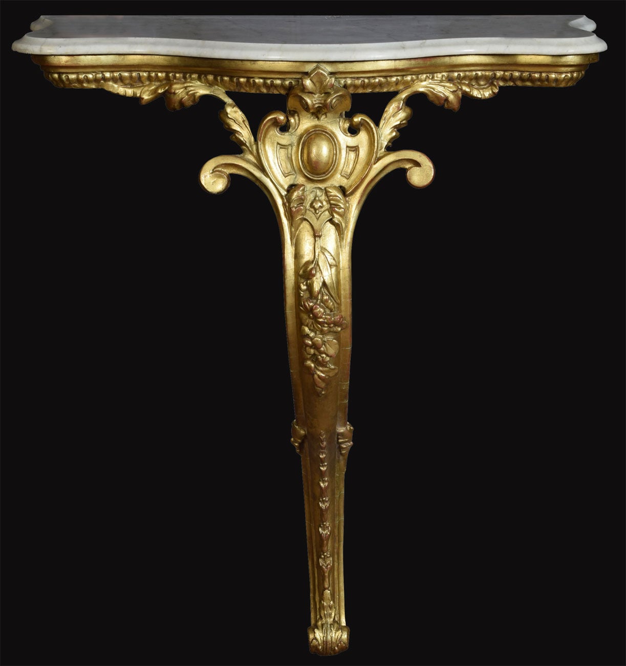 Victorian gilt wood marble top console table, the top with serpentine borders, on a carved gilt frame with single leg, with all over floral and scrolling carved decoration.

Dimensions

Height 35 Inches

Width 30.5 Inches

Depth 14 Inches