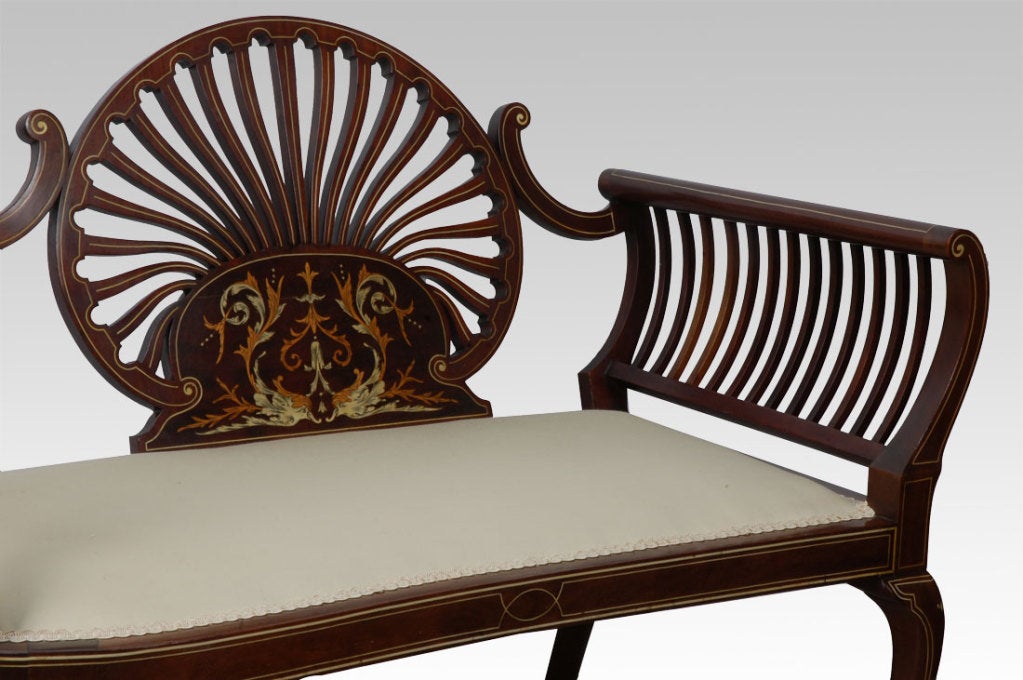 Late Victorian inlaid mahogany two setter boudoir couch, the mahogany frame with fan shaped inlayed splat having upholstered back and seat raised up on cabriole front leg supports