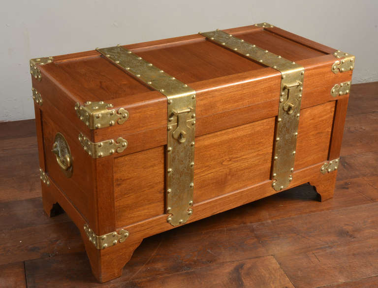 Chinese brass bound Campaign box of large proportions, the lid having finely tooled brass bound straps riveted corners opening to reveal large storage area, the front having double lock, flanked by carrying handles to the side raised up on bracket