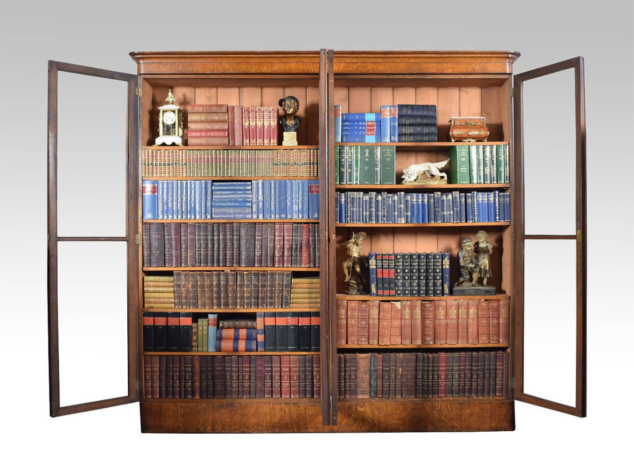 Victorian oak library bookcase the moulded cornice above four large glazed doors opening to reveal four sections of adjustable shelves all raised up on plinth base

Dimensions

Height 96.5 Inches

Width 99 Inches

Depth 15 Inches