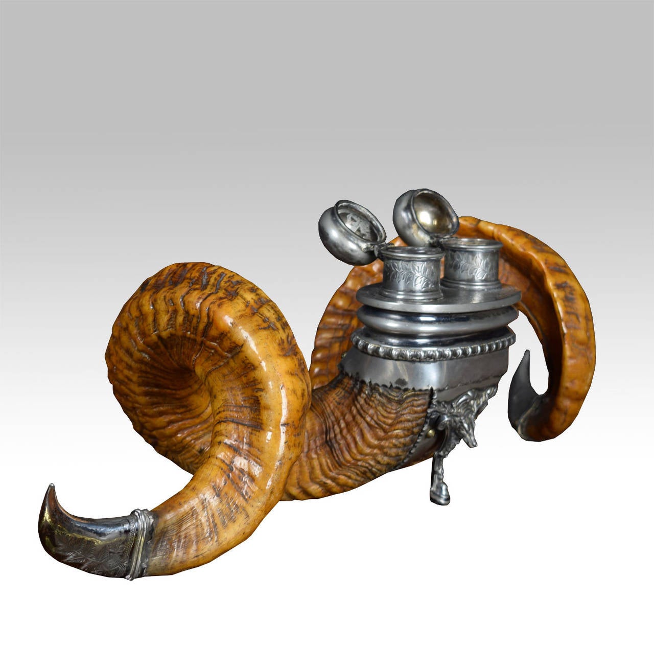 Rare English Ram's Horn with silver plate Inkwell by Walker & Hall, the horns are mounted with engraved tips with similar engraving to the double inkwell in the centre. The front of the inkwell having a cast Stag's head and a hoof foot supporting