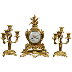 French three piece gilt metal mantle clock set