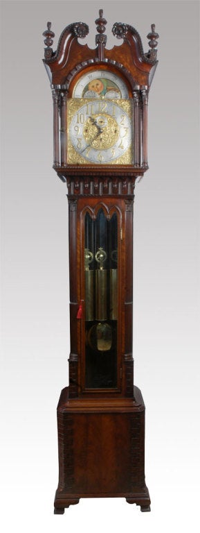 Chippendale revival flame mahogany long case grandfather clock. This clock represents the finest tall clock of its period. The complicated 8 day 3 train movement By J.J. Elliott. The chimes on the quarter hours on 8 Harris & Harrington tubular