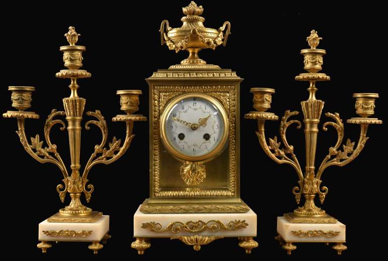 Louis XVI style gilt metal and white marble three-piece clock set