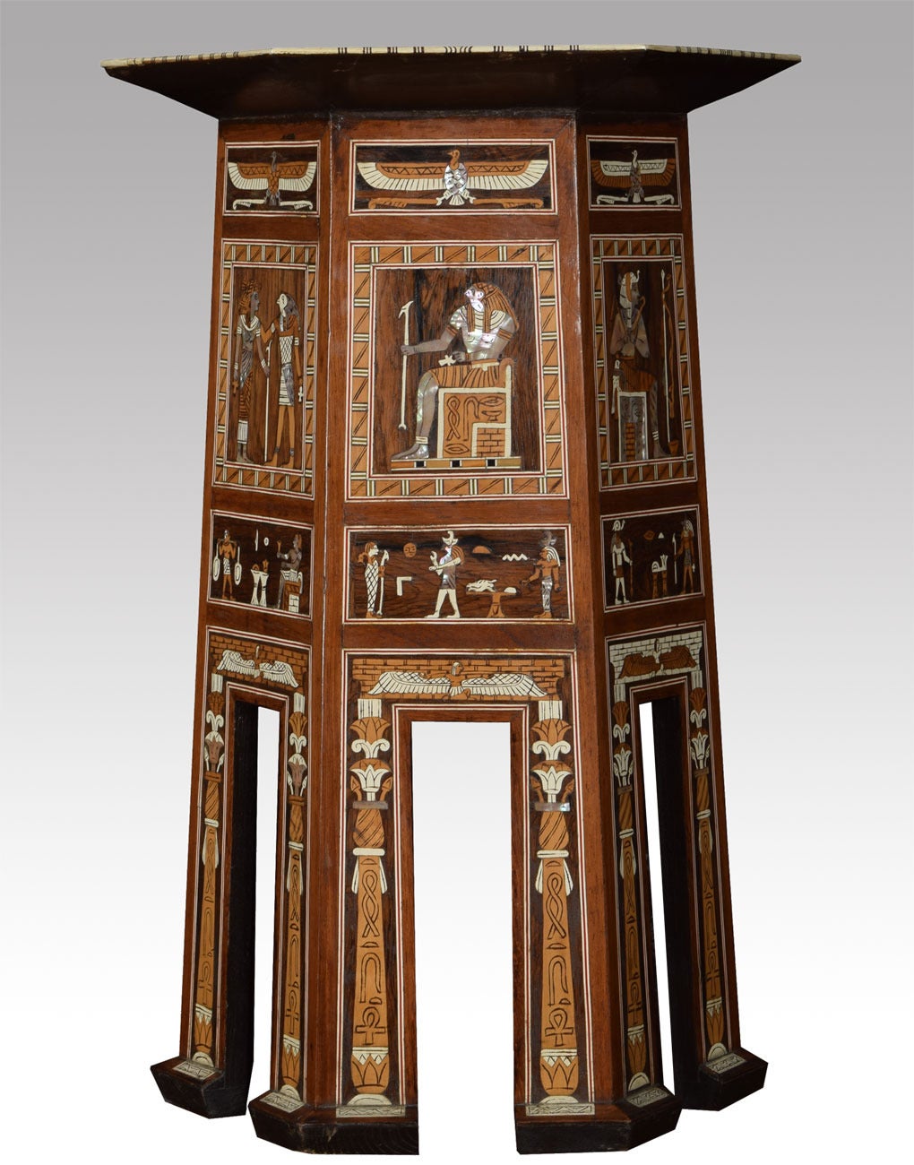 One of kind 19th century Egyptian hexagonal inlaid pedestal table inlaid with mother of pearl, tortoise and ebony the profusely inlaid top above swept supports, with typical Egyptian depictions, set within an intertwining lotus