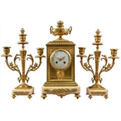 Louis XVI style gilt metal and white marble three-piece clock set