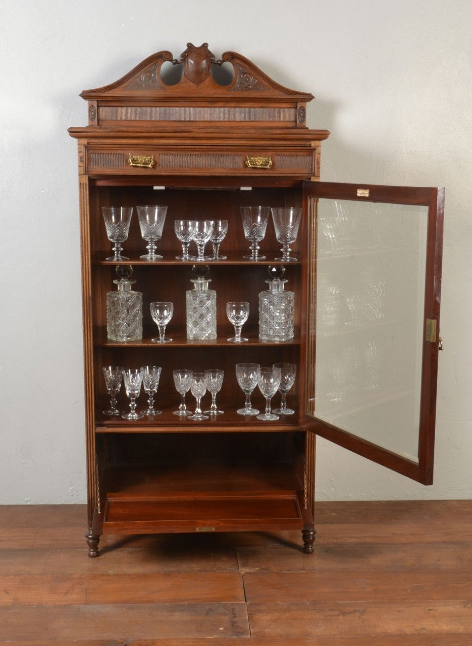 Edwardian mahogany display cabinet, with swan neck back and single drawer, with reeded sides, bevelled glazed door and inner shelves, over fall fronted drawer, on turned legs, bearing makers label Wylie & Lochhead Ltd