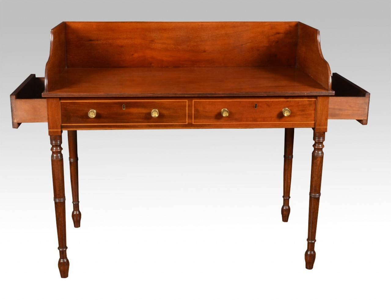 Regency mahogany wash stand, in the manner of Gillows with raised three quarter gallery to the large rectangular mahogany top, above two false drawers having single draw to either end, all raised up on finley fluted ring-turned