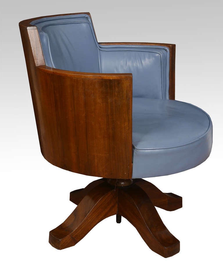 Mahogany framed Art Deco swivel office chair the raised back above upholstered blue leather seat and arms raised up on four legs