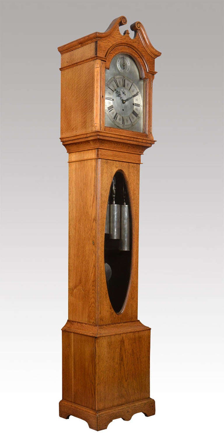 Victorian oak musical and quarter chiming long case clock Having arched silvered dial with Roman numerals, the arch with Westminster Chimes/Silent , the movement striking on a large single tube, and chiming on four graduated tubes, the case having a