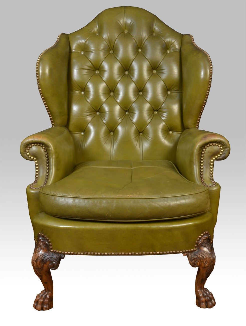 British Pair of leather wing armchairs in the George II style