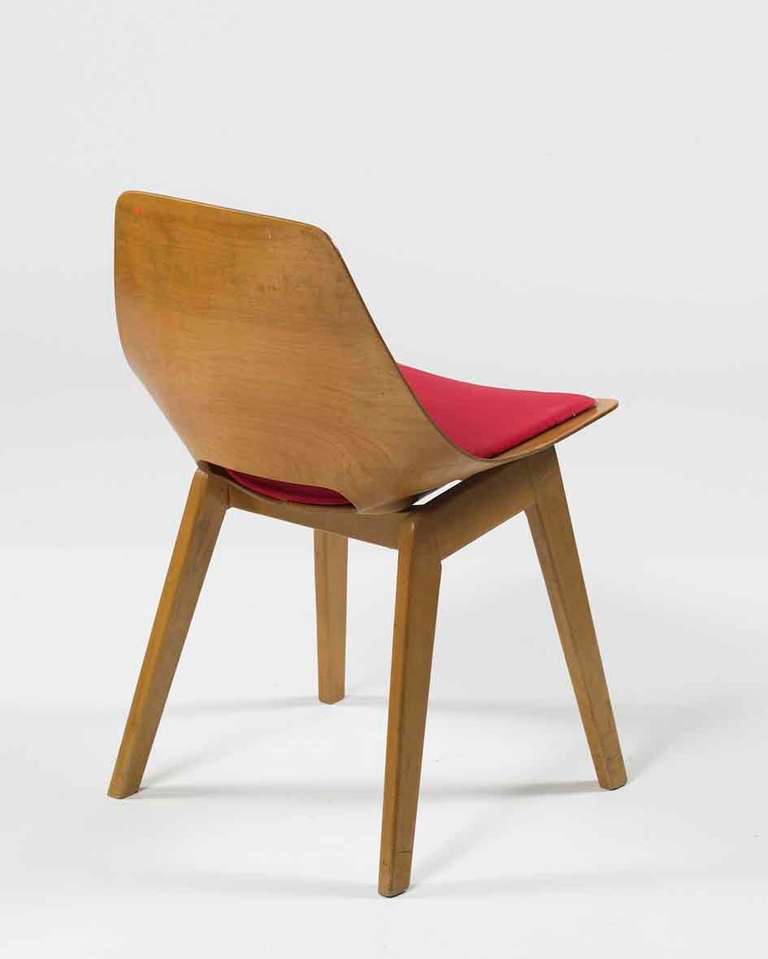 Wood chair, wood base, plywood chair. Natural wood and seat in red fabric.

- 