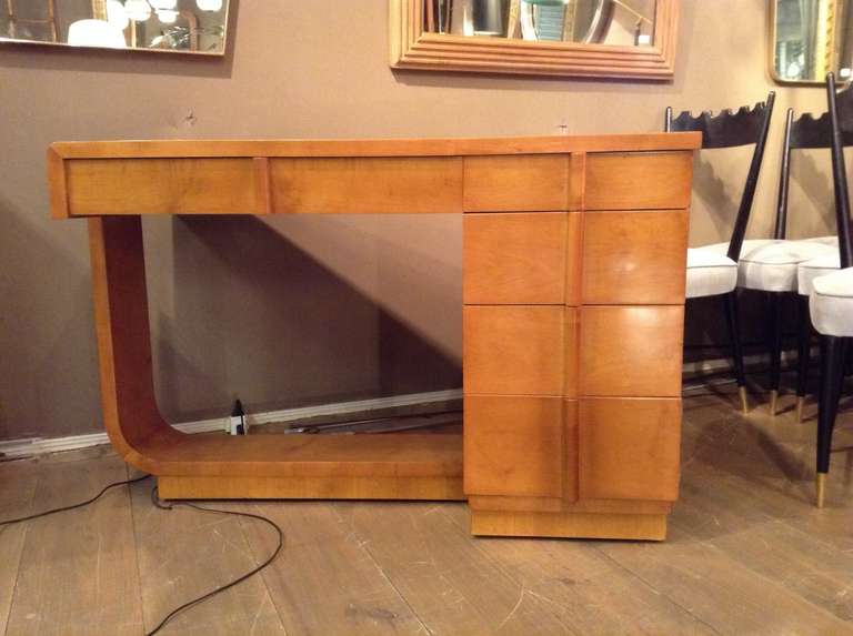 Beautiful circa 1940 blond sycomore desk. Modernist shape with four drawers. The last opening like a door. Rectangular base.