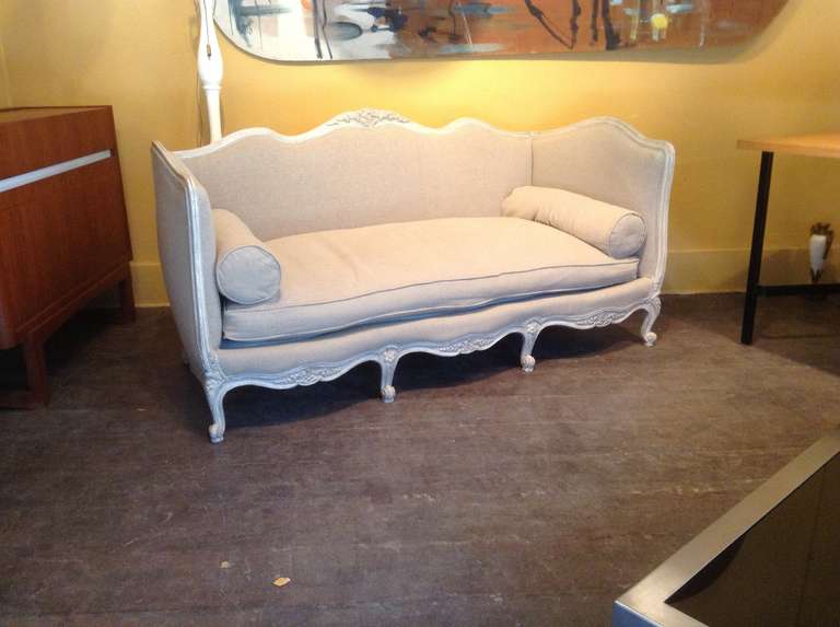 Small Louis XVI style sofa with grey patina. New fabric and upholstery. Sinuous feet and curved back and armrests.