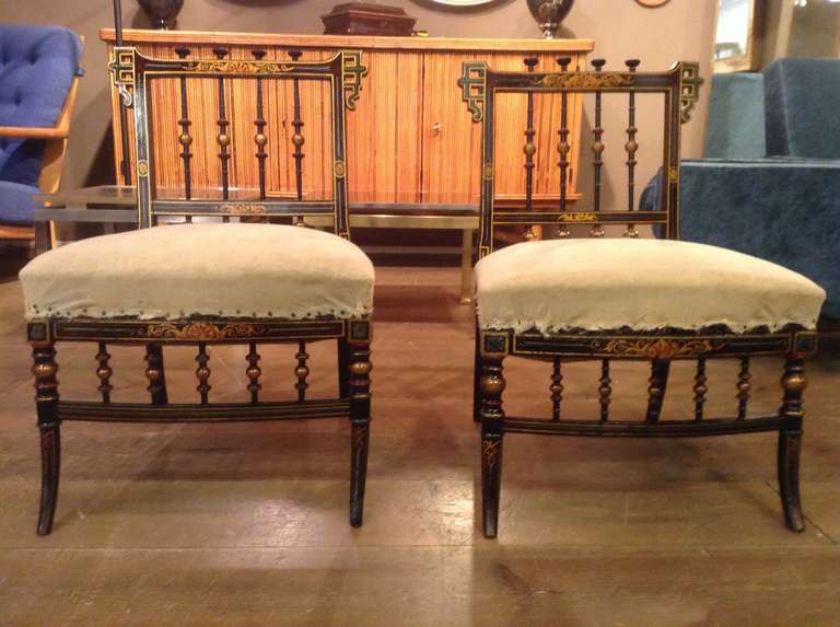 Ebonised wood with painted decor chauffeuse chairs. Fabric to be renewed.