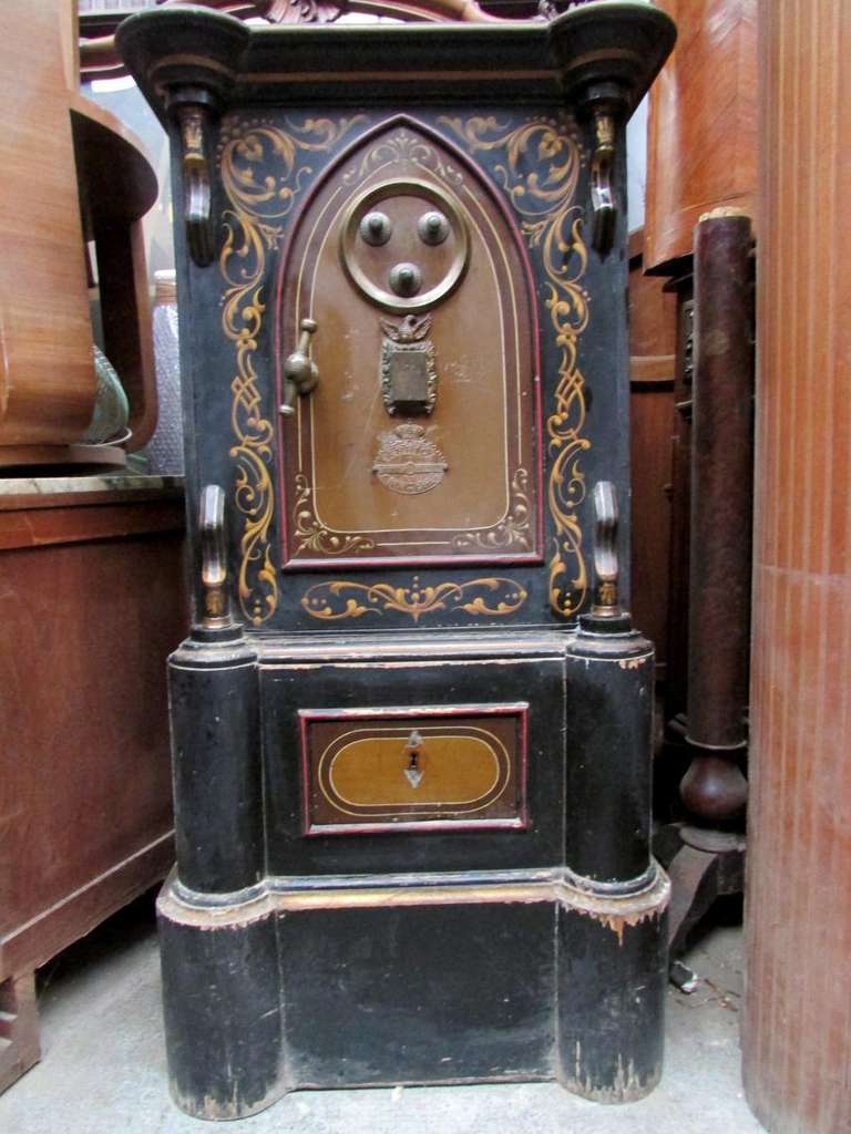 colonial iron safe 
19th century napoleon III
was manufactured in Portugal for its colonies ( Brazil, Africa )
the original exterior patine was saved
the keys and the secret code are available
the top and the base are in pine wood painted black