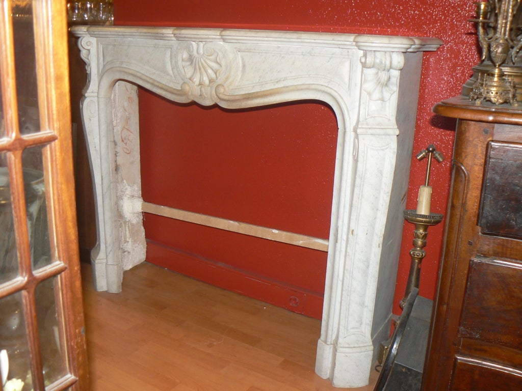 1880's chimney fireplace mantel 
louis the fifteen style
white carrara marble 
bombée curved
with 3 shells
If you have visited our website (www.marceauantiques.com) and you want more information, please contact us through our 1stdibs account.