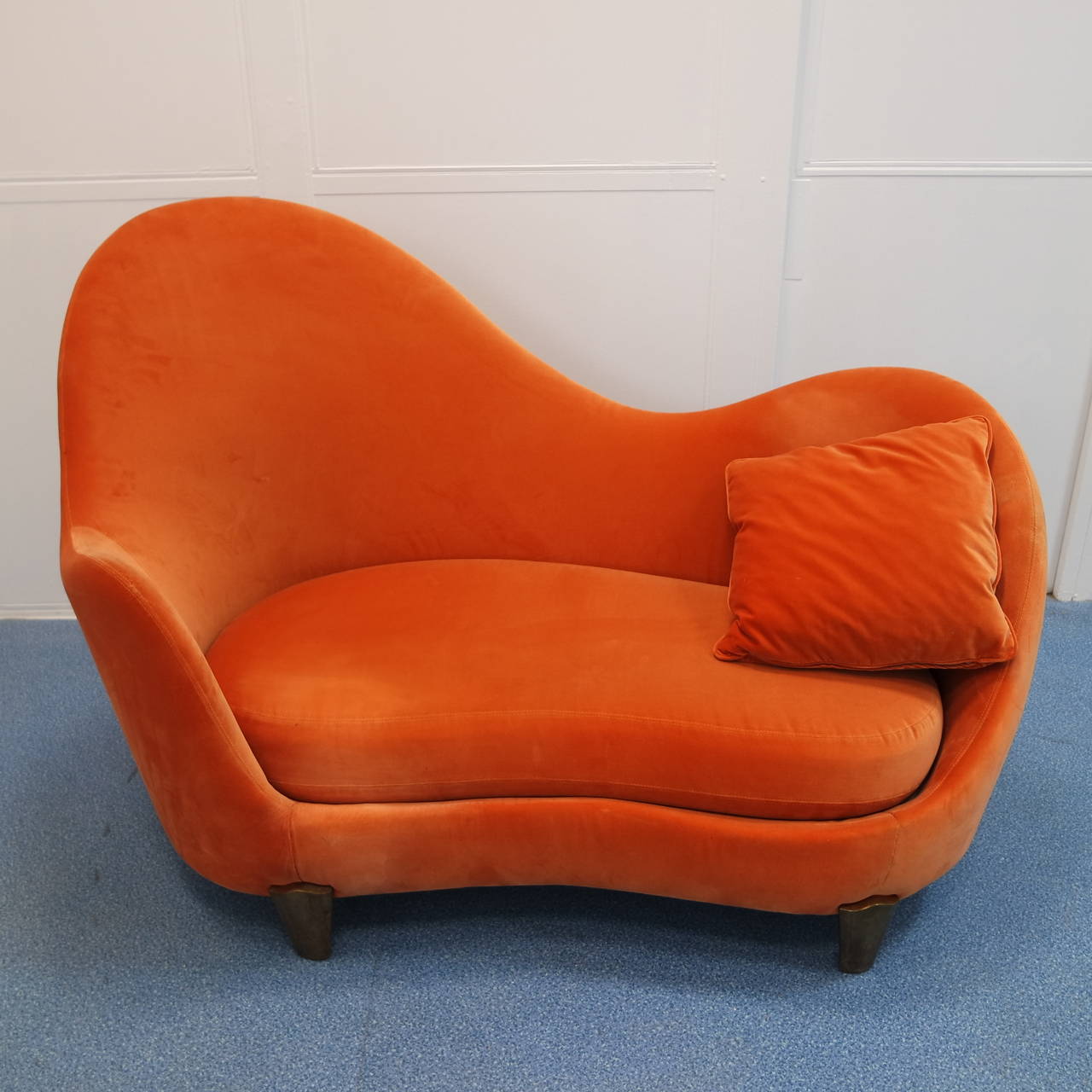Famous sofa by Garouste & Bonetti with a wavy back and bronze feet covered with an orange velvet fabric.