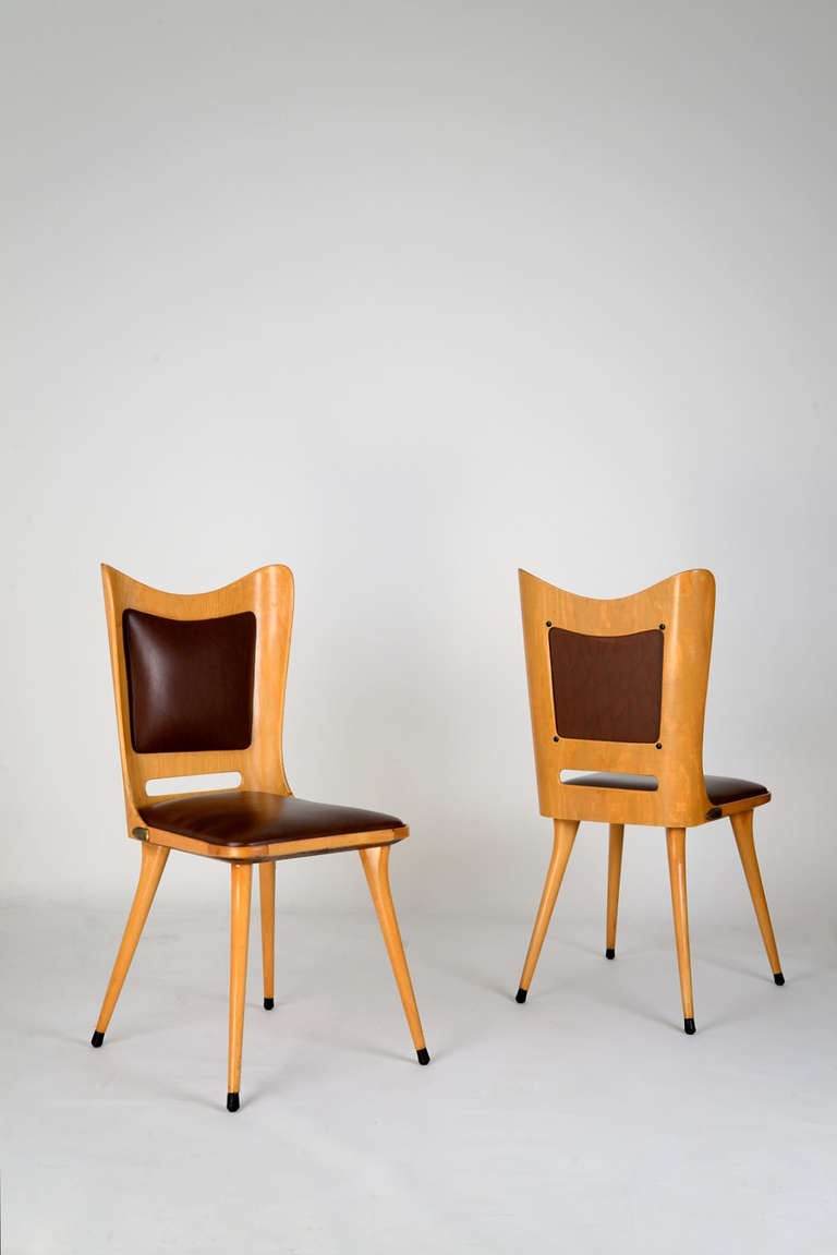 Set of six plywood and vinyl chairs in the style of Carlo de Carli, manufactured in Italy in the '50s.