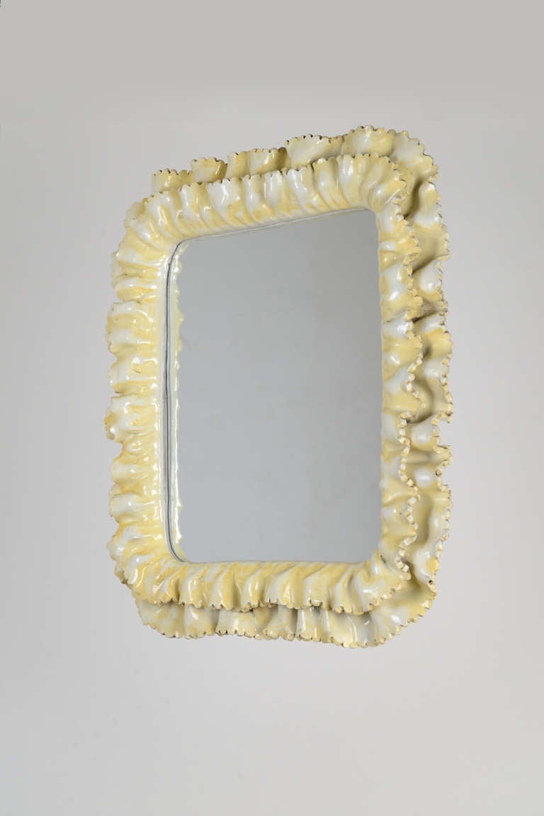 Exquisite glazed ceramic mirror with small console in the manner of Fausto Melotti, manufactured in Italy in the '50s.