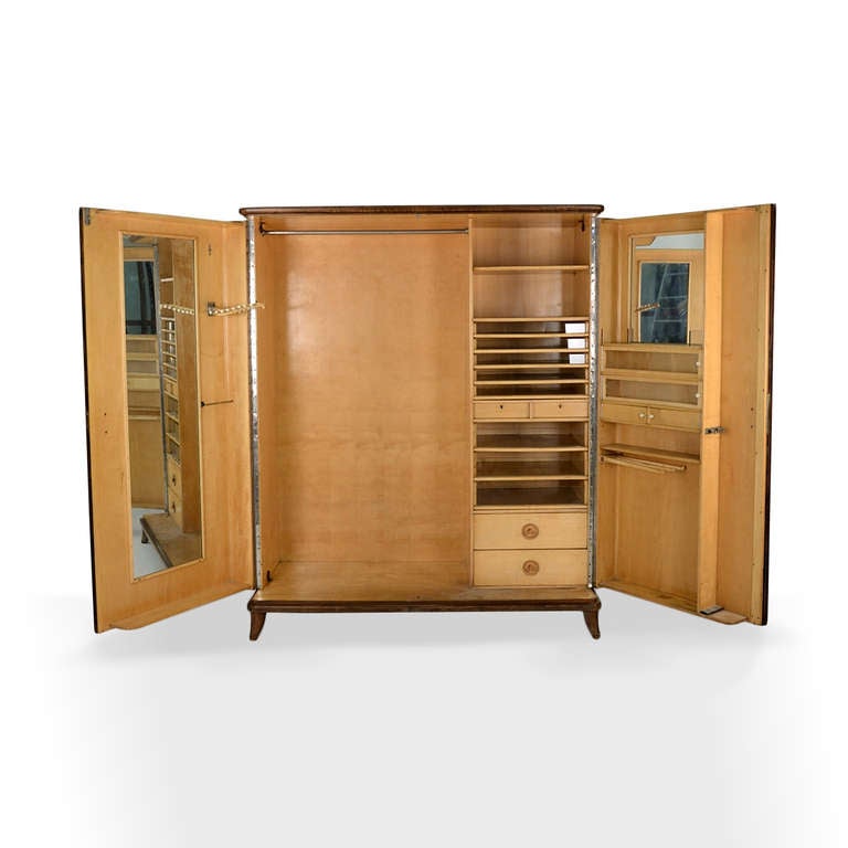 Extraordinary wardrobe / armoire manufactured in Italy in the '40s. As one can notice in the pictures, the inside is exquisitely made and offers elegant vintage accessories such as the stick holder, the tie hanger, glass drawers, a full size mirror