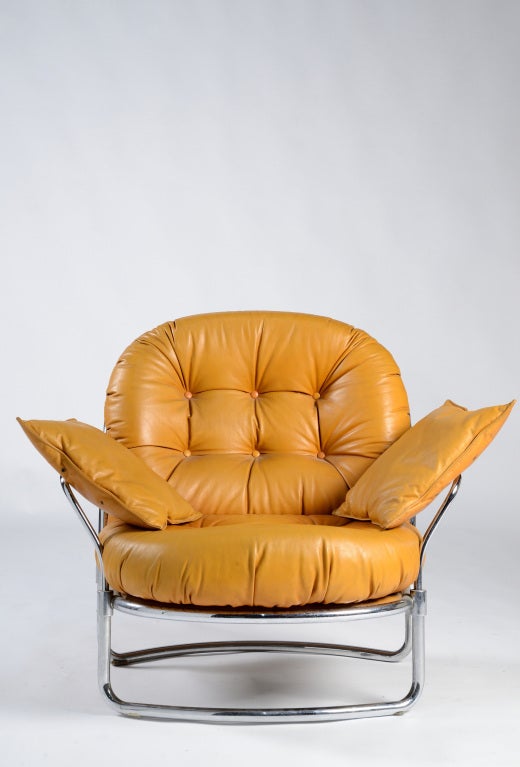 Old stock leather lounge chair with ottoman by Carlo De Carli, manufactured by Cinova in 1969. This item still has its original leather cushions to protect arms from metal armrests.