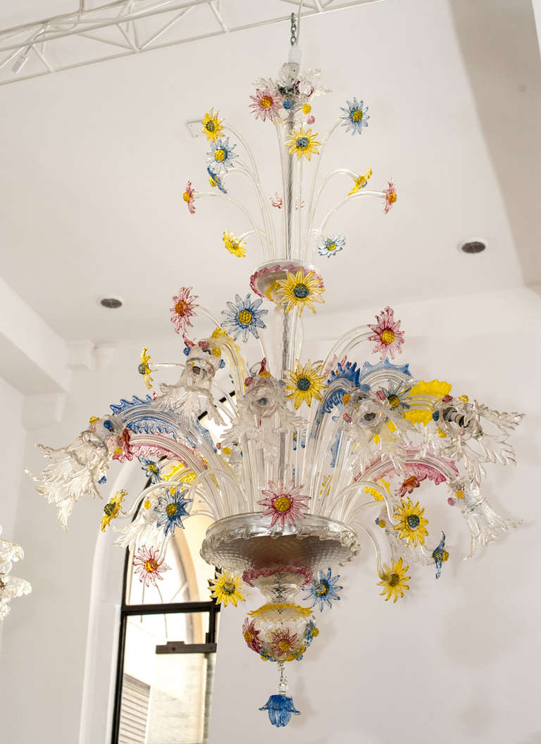 Big 12 lights chandelier, richly decorated with multicolored glass flowers.

Murano, circa 1930.
 