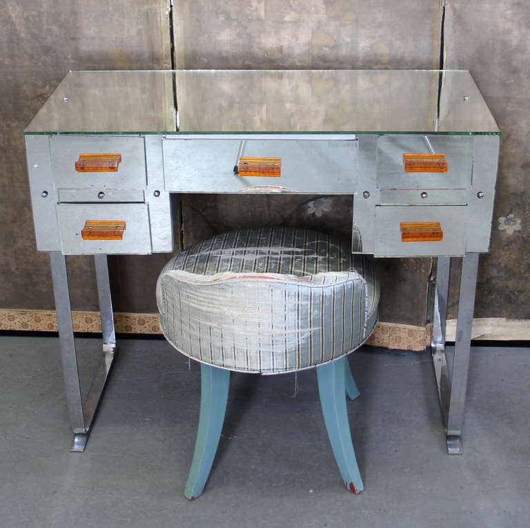 Art Deco Machine Age Modern mirrored 5 drawer vanity with chrome legs and bakelite pulls with stool.
36