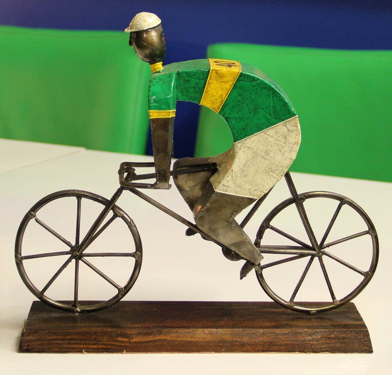 Wonderful an whimsical iron and paper mache sculpture of a racing cyclist by Manuel Felguerez. Signed with brass tag on the wood base.
