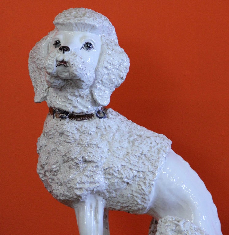 Unusually Large Italian Pottery Sculpture of a Standard Poodle seated on a tasseled pillow. Well modeled and nearly life size this is rare opportunity to own a really unique piece of Italian pottery. Marked on base 2G2LG? Italy
