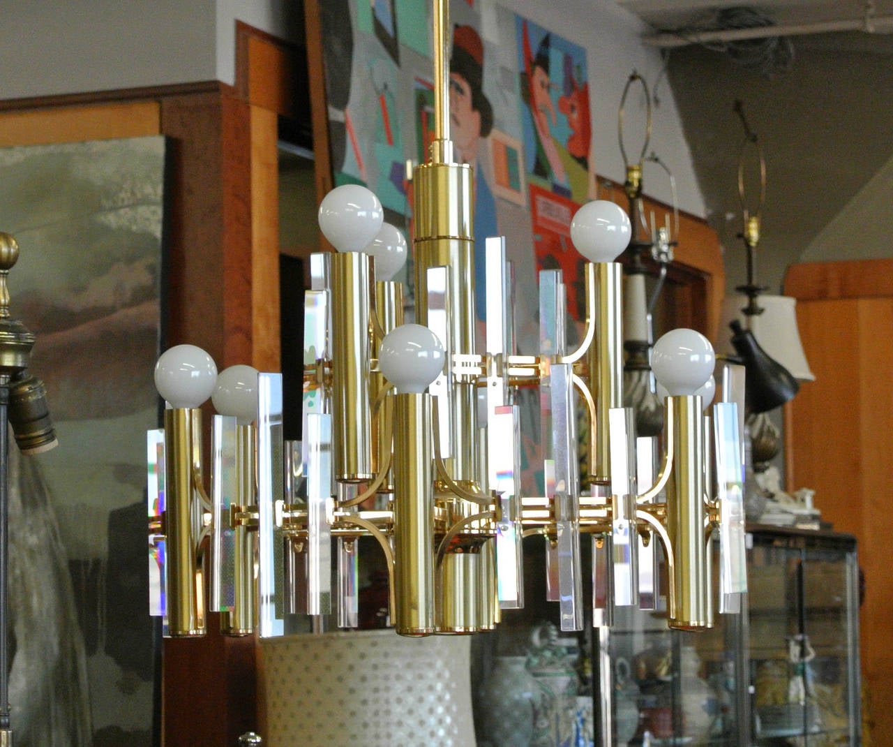Late 1970s/Early 1980s Brushed Brass and Crystal Nine Light and Two Tiered Chandelier Attributed to Gaetano Scolari. Shown with style appropriate round lightbulbs. The chandelier also has gilt framework details. There are nine 8