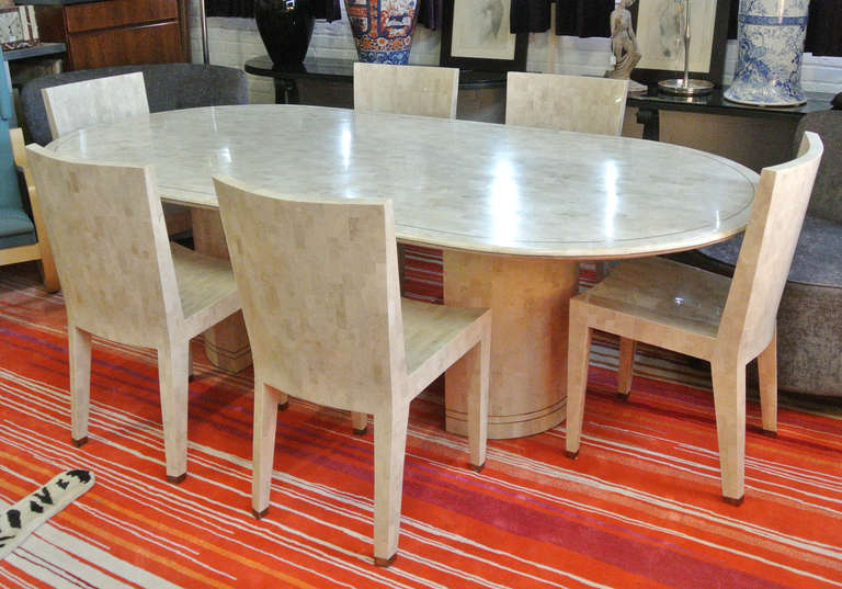 Karl Springer tessellated fossilized coral dining table with brass inlay. Fully labeled and in excellent condition. Please see our other listings for more documented Karl Springer selections including a rare set of JMF dining chairs.