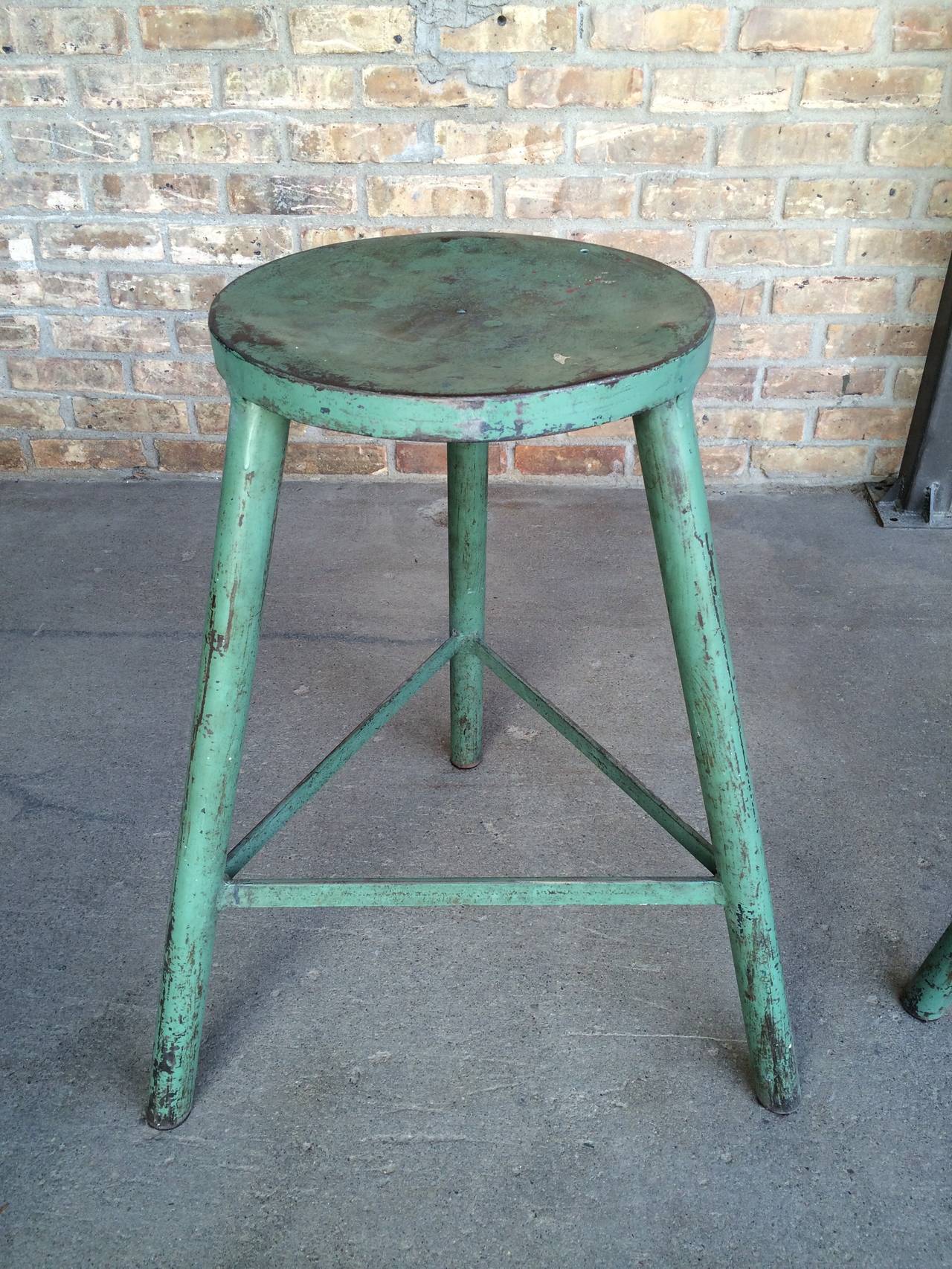 Vintage industrial iron metal stools with original paint and fabulous patina.