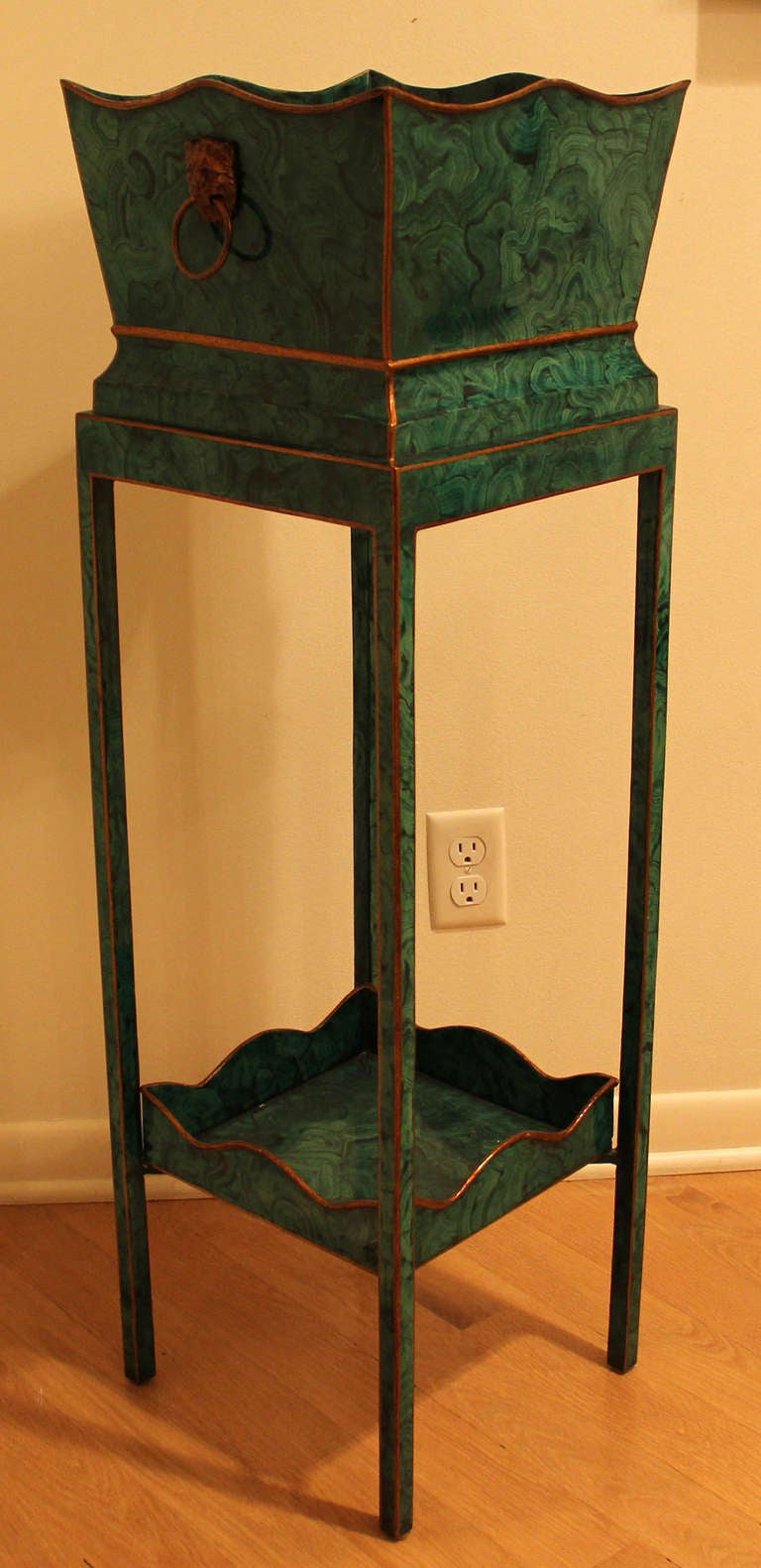 A nice labeled two tier  Maitland-Smith faux malachite plant stand with gilt lions head handles. Measuring 40.75